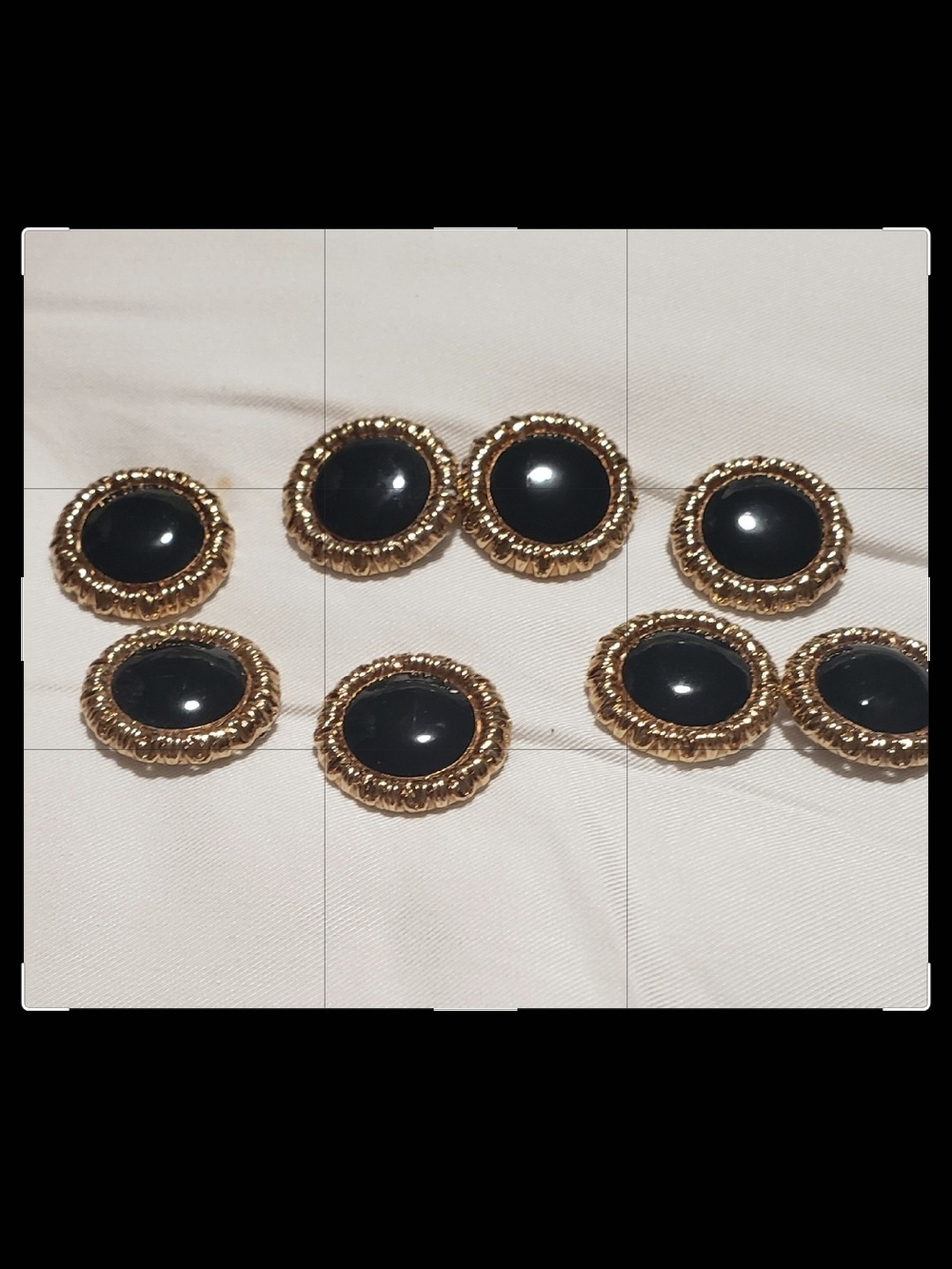 St. John Gold-Tone Buttons with Black Cabochons.